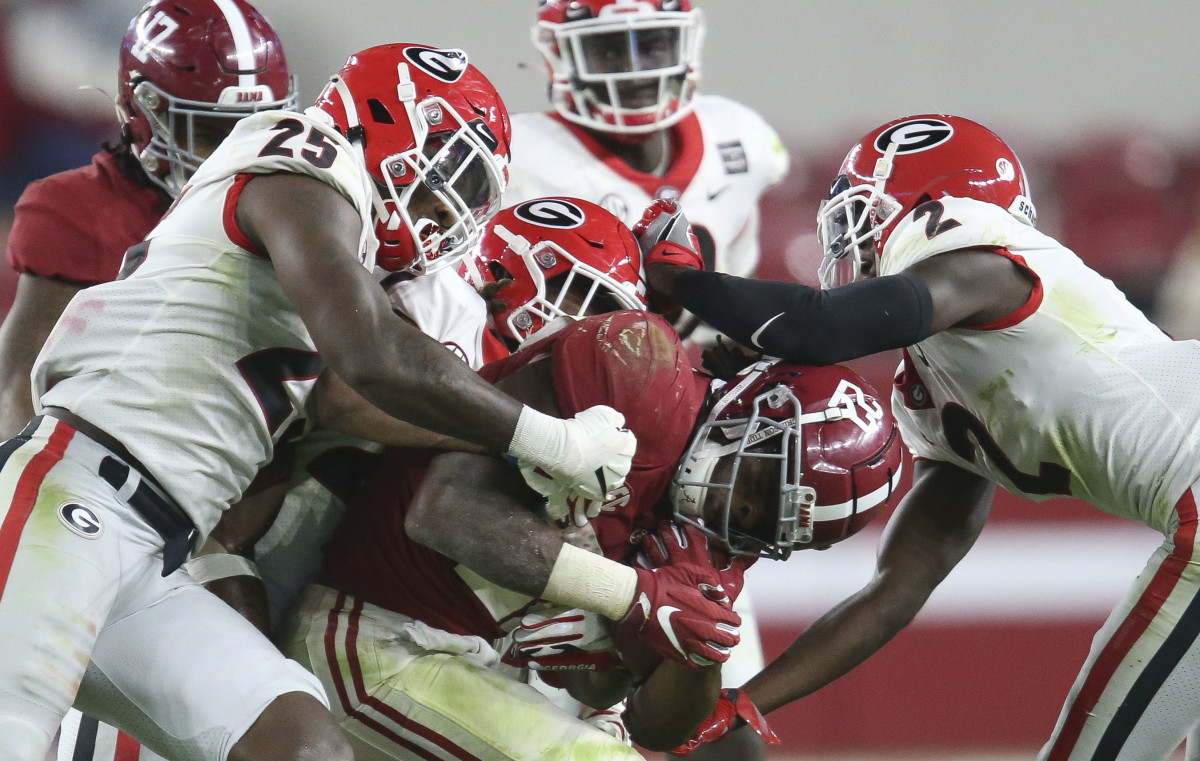 Oct 17, 2020; Tuscaloosa, Alabama, USA; Georgia defenders swarm Alabama running back Najee Harris (22) as he runs the ball during the second half of Alabama's 41-24 win over Georgia at Bryant-Denny Stadium.
